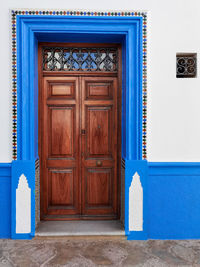 Brown traditional wooden door in the old medina of asilah