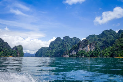 Scenic view of sea and mountains against sky