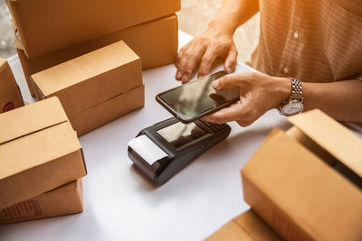 Close-up of human hand holding paper box