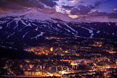 High angle view of illuminated town against sky at night