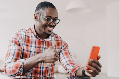 Side view of man using mobile phone