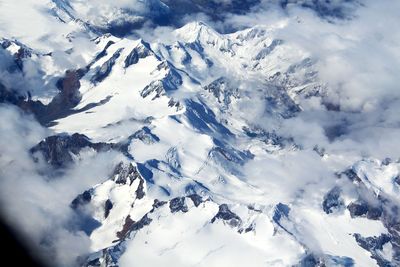 Scenic view of snow covered mountains against sky