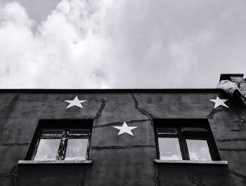 Low angle view of building with stars against sky