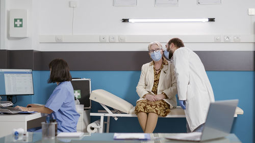 Doctor examining ear of patient in medical clinic