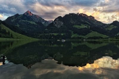 Scenic view of lake and mountains against sky