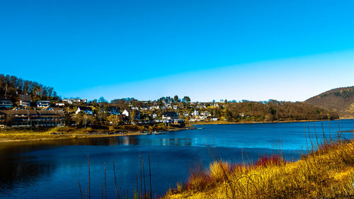 Scenic view of lake against blue sky