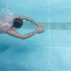 High angle view of woman swimming in pool