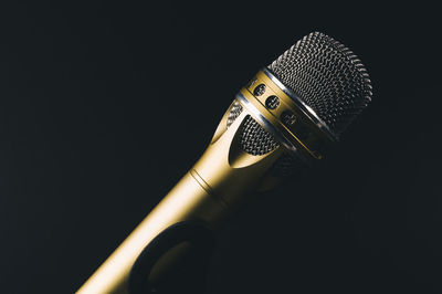 Close-up of microphone against black background