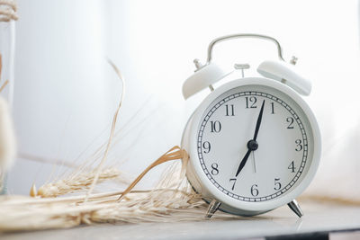 Close-up of clock on table at home