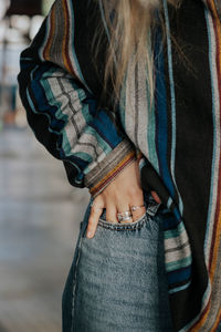 Midsection of girl in striped shirt with rings