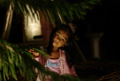 Portrait of girl standing outdoors at night