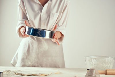 Midsection of woman holding smart phone