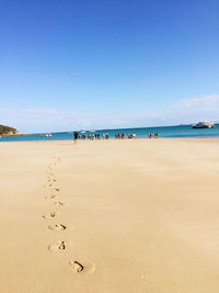 Scenic view of beach against blue sky