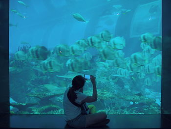 Full length of girl swimming in aquarium