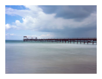 Pier on sea against sky