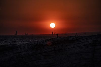 Scenic view of beach against sky during sunset