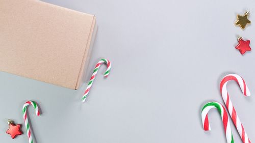 Directly above shot of multi colored confetti against white background