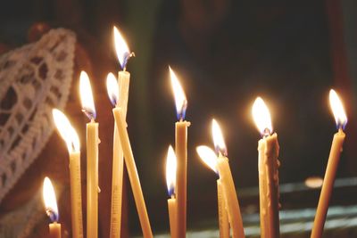 Lit candles burning in temple