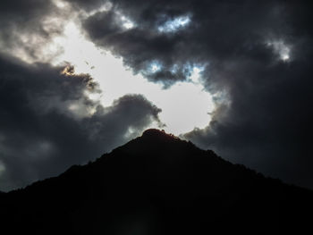 Low angle view of silhouette mountain against sky