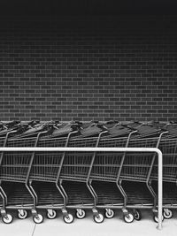 Shopping carts arranged in a row by wall