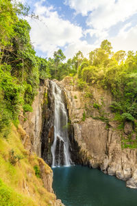 Scenic view of waterfall against sky