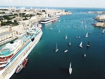 High angle view of cityscape by sea against sky