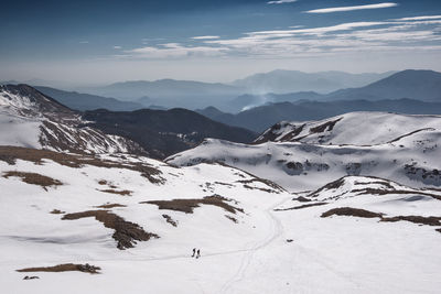 Scenic view of snow covered mountains against sky