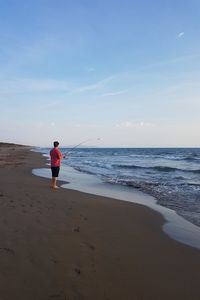 Beach crab fishing in tuscany at sunset