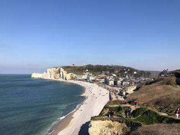 Panoramic view of sea and buildings against clear blue sky
