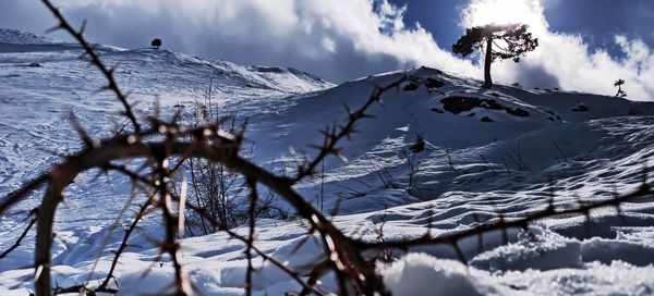 Scenic view of snow covered mountains against sky