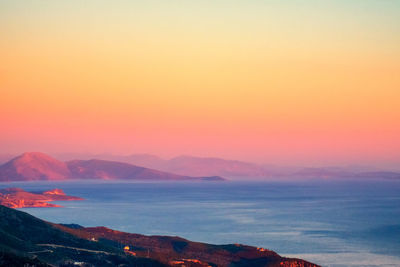 Scenic view of sea against romantic sky at sunset