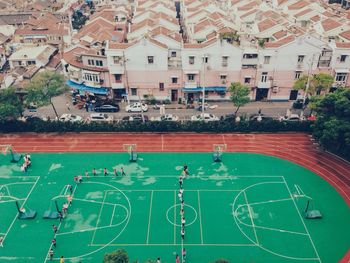 High angle view of school students running in basketball court