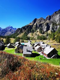 Scenic view of mountains against clear blue sky