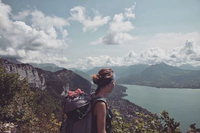 Woman looking at mountains and lake
