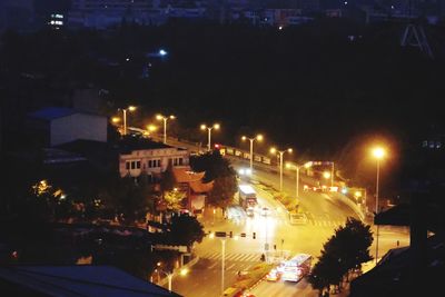 High angle view of illuminated street and buildings at night