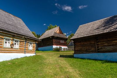 Houses on field against sky