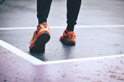 Low section of person standing on road