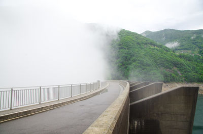 Scenic view of river against sky during foggy weather