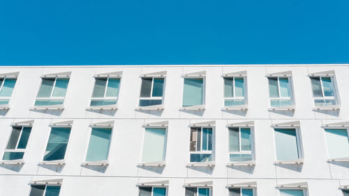 Low angle view of building against clear blue sky