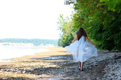 Full length of woman standing on tree