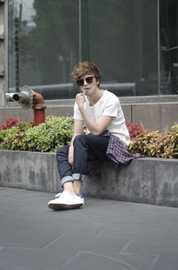 Young man sitting outdoors