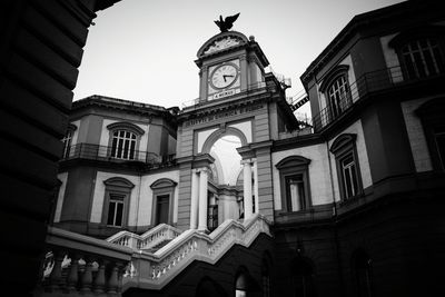 Low angle view of clock tower against sky