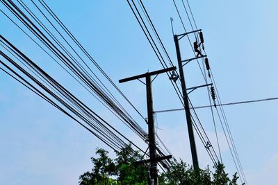 Low angle view of electricity pylon against sky