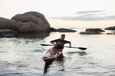 Man kayaking in river