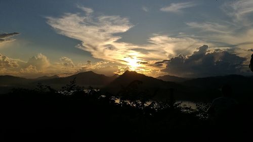 Scenic view of silhouette mountains against sky at sunset