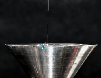 Close-up of water drops on glass against black background