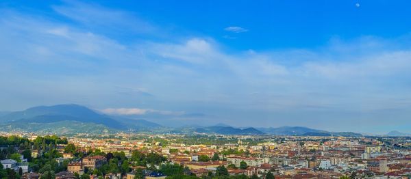 High angle view of town against blue sky