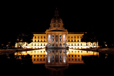 Reflection of building in water at night