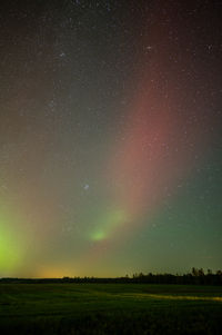 Scenic view of field against sky at night