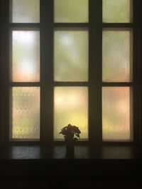 Close-up of flower vase on window sill